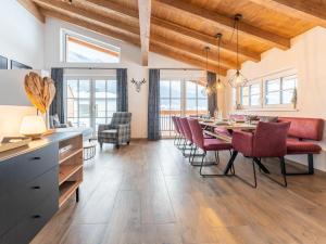 a kitchen and dining room with a table and chairs at Chalet Aquila in Niedernsill