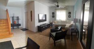 a living room with a couch and a tv at Ocean Villa Supreme in Bailey Town