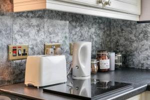 a kitchen counter with a white appliance on a counter top at 2 Bed Apartment near Belfast & Ferry in Belfast