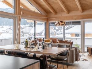 穆勞附近聖格奧爾根的住宿－Kreischberg The Exclusive Eight，一间带桌椅和窗户的用餐室