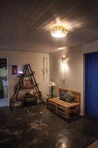 a room with a bed and a ladder and a light at Calango Hostel in Ibicoara