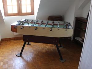a foosball table in the corner of a room at Gîte Conflans-sur-Anille, 6 pièces, 11 personnes - FR-1-410-182 in Conflans-sur-Anille