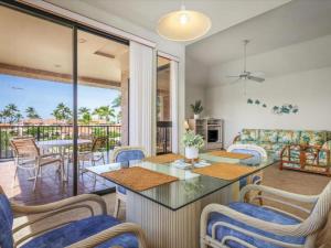 a living room with a table and chairs at Shores at Waikoloa 301 - MCH in Waikoloa