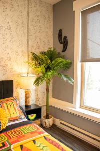 a bedroom with a palm tree in a room at The Sahara #3 in Bellefontaine