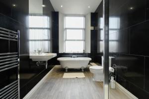 Suite in the heart of Great Harwood في Great Harwood: حمام مع حوض ومغسلة ومرحاض