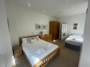 a bedroom with two beds in a room at Holiday Home Hot Tub & Sauna in Bournemouth +40 photos
