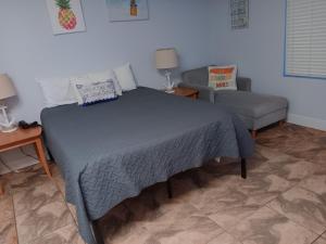 a bedroom with a bed and a couch at Ocean Walk Resort - Dramatic 3 BR Ocean Front View in Daytona Beach +46 photos