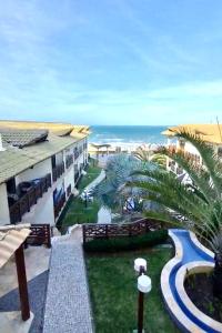 a view of the ocean from the balcony of a resort at Apto 2 quartos - Condomínio Frente Mar in Beberibe