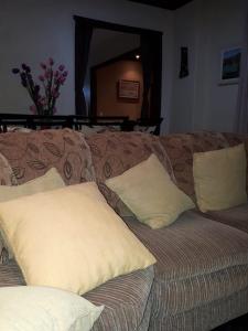 a couch with two pillows on top of it at Chacara Salmo 27 in Antonina