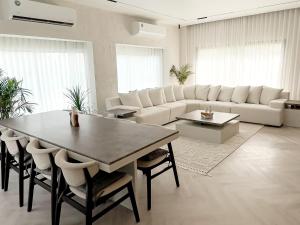 a living room with a table and a white couch at Moon mountain villa 