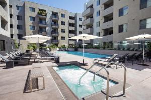 a swimming pool with chairs and umbrellas in a building at Cozy Huge LOFT for Live and Work in Los Angeles