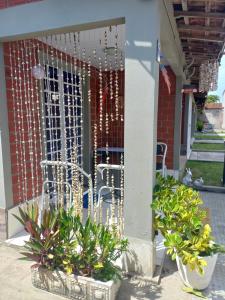 a porch with a fence and some plants at Condomínio da Barra - Chalé 6B in Tamandaré