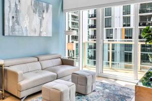 a living room with a couch and chairs and windows at *Spacious 2BR Loft Brickell W/Stunning Views* in Miami