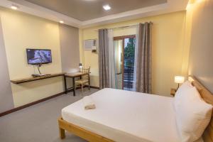 Dancels Inn في أورموك: غرفة بسرير ومكتب وتلفزيون