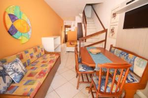 a living room with a table and a couch at Apartamentos Villa Porto do Sol in Bombinhas