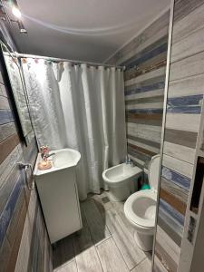a bathroom with a toilet and a sink at Chill Out Piria 2 in Piriápolis