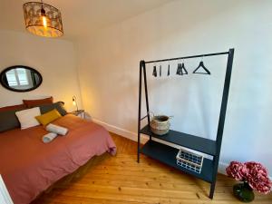 a bedroom with a bed and a shelf at Le Saint-André, Gare de Rouen in Rouen