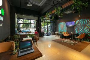 a room with a laptop on a table in a restaurant at Hai Mươi Hotel & Apartment in Hanoi