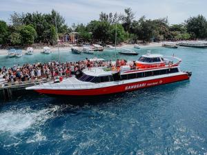 a group of people on a boat in the water at Gili Ferries Ganggari Speedboat in Padangbai