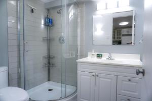 a bathroom with a shower and a sink and a toilet at Free Parking - Great 1BR near Henri Bourassa Metro in Montreal