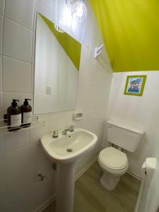 a bathroom with a sink and a toilet and a mirror at Camino al Río in Viedma