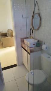 a bathroom with a toilet and a sink and a shower at Casa de Veraneio em Itapema - BA in Santo Amaro