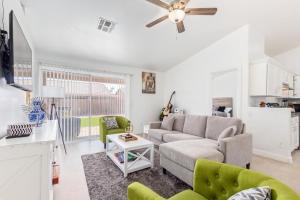 a living room with a couch and a ceiling fan at Vernon House - Stunning Cozy Vacation Home Near State Farm Stadium with Gym-Kitchen-Free Parking in Phoenix