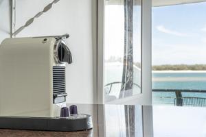 a hair dryer sitting on a counter next to a window at La Promenade in Caloundra