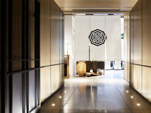 a hallway in a building with a sign on the wall at Millennium Mitsui Garden Hotel Tokyo - Ginza in Tokyo