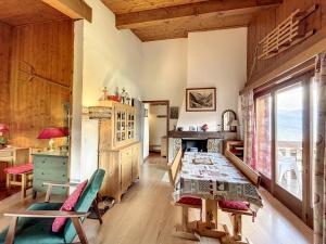 a room with a table and chairs and a window at Charmant 2 pièces au centre de Combloux avec vue Mont Blanc - FR-1-560-9 in Combloux