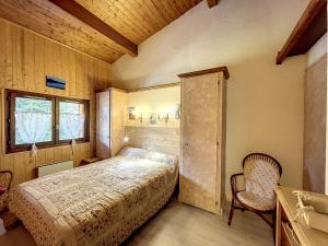 a bedroom with a bed and a window and a chair at Charmant 2 pièces au centre de Combloux avec vue Mont Blanc - FR-1-560-9 in Combloux