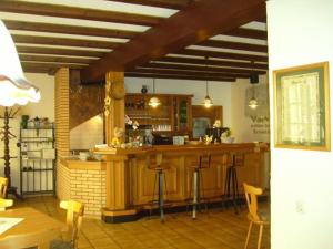 a kitchen with a bar with stools in it at Alte Winzerschenke in Bruttig-Fankel