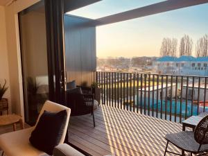 a balcony with a view of a swimming pool at Top Floor Luxury City Central w Sunny Balcony in Christchurch