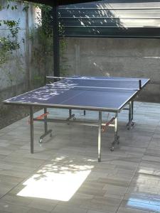 a ping pong table sitting on a patio at Casa Aislada Peñaflor-Malloco in Santiago