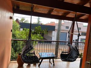 a porch with two hammocks on a balcony at Departamento Oberá amplio zona centro in Oberá