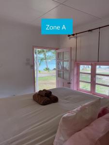 a bedroom with a large bed with towels on it at Siam Beach Resort Koh Kood in Ko Kood