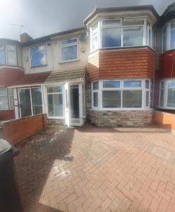 a house with a brick driveway in front of it at Harington Homes in Palmers Green