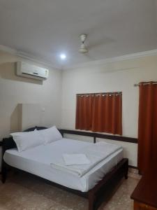 A bed or beds in a room at CORRIDOR CALICUT Airport Hotel
