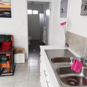 a kitchen with a sink and a bathroom at Gumnut Getaway BnB in Goolwa North