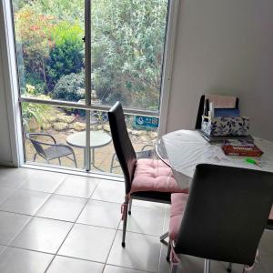 a dining room with a table and chairs and a window at Gumnut Getaway BnB in Goolwa North