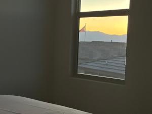 a room with a window with a view of a flag at Breeze Valley Homestay in Tucson