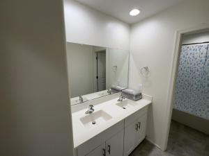 a bathroom with two sinks and a large mirror at Breeze Valley Homestay in Tucson