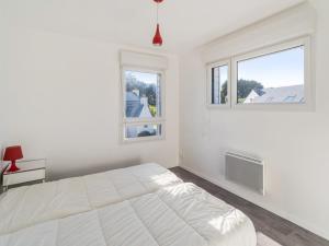 a white bedroom with a bed and two windows at Villa lumineuse 4 étoiles, 50m de la plage, jardin clos, tranquillité à Trégastel - FR-1-368-399 in Trégastel