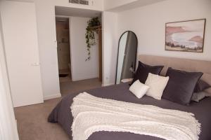 a bedroom with a large bed in a room at Amara at Solaris in Forster