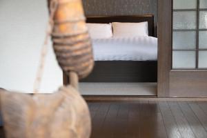 a view of a bedroom with a bed in the background at ちどり庵 in Shio