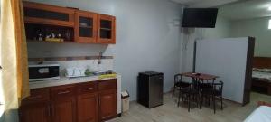 a small kitchen with a table and a refrigerator at Mini Departamento Iquitos 1243 in Iquitos