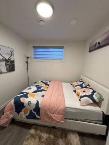 a bedroom with a bed with cows on it at Brand new 1 Bedroom Basement Suite. Wi-Fi,Netflix in Edmonton