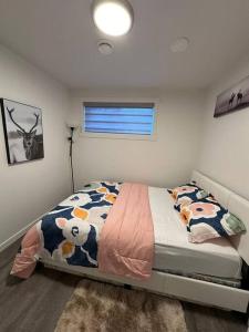 a bedroom with a bed with cows on it at Brand new 1 Bedroom Basement Suite. Wi-Fi,Netflix in Edmonton