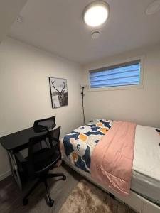 a bedroom with a bed and a desk and a desk at Brand new 1 Bedroom Basement Suite. Wi-Fi,Netflix in Edmonton