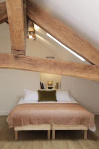 a bedroom with a bed in a attic at Maison Le Moulin Vert by La Boîte En Plus in Senlis